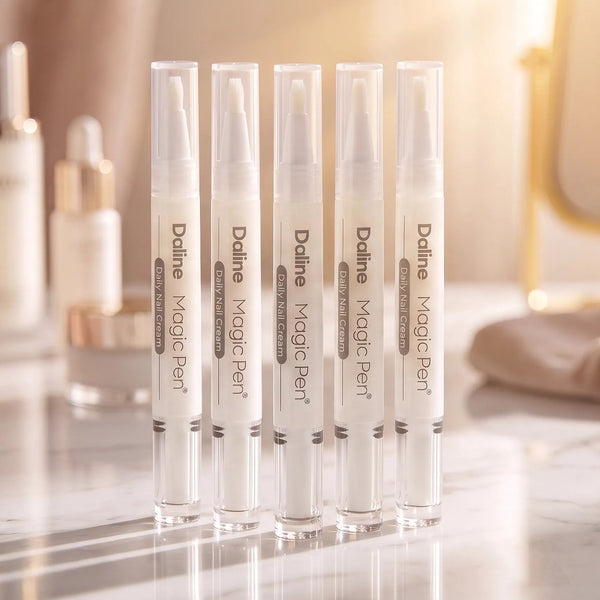 Six Daline Magic Perf makeup tubes arranged in a row on a marble surface with a softly blurred vanity background.