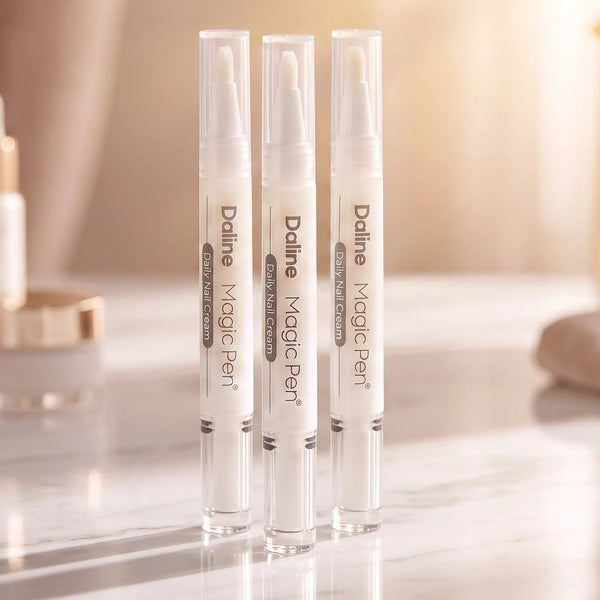 Three Daline Magic Pen correction pens standing upright on a glossy marble surface, with a softly blurred cosmetic bottle in the background.