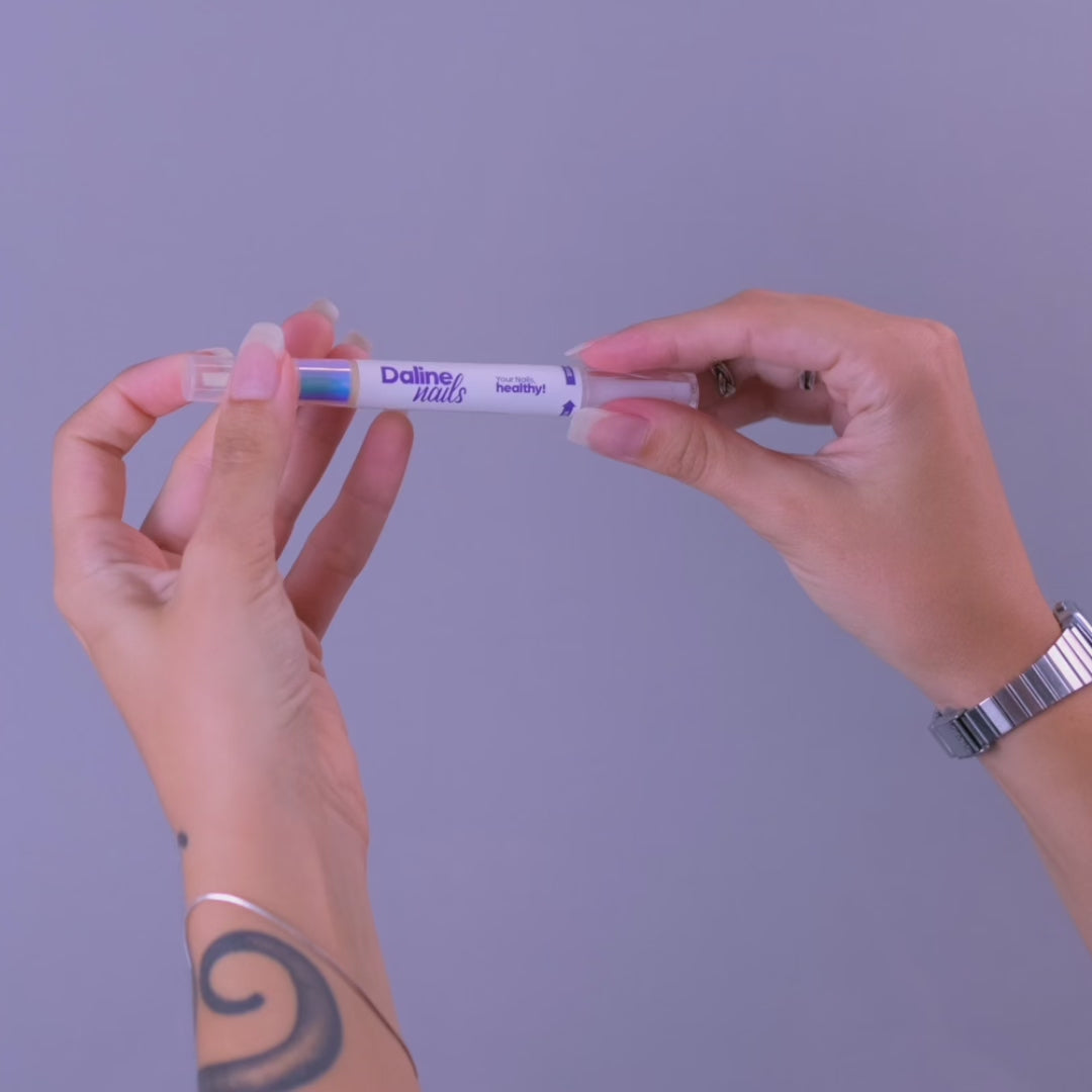 hands showing how to apply magic pen on the nails and cuticles.